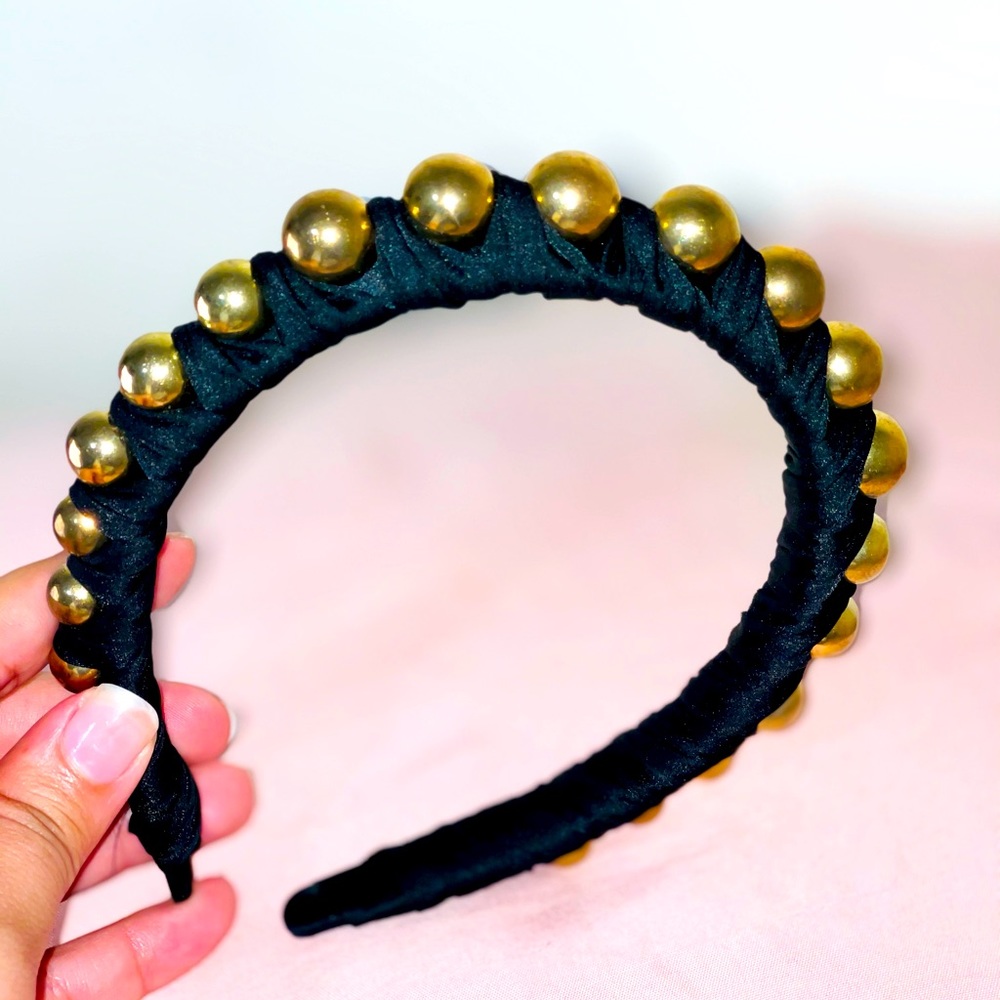 Black hair band with gold balls.